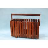 A rosewood magazine rack, with slatted sides