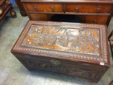 An Oriental carved camphorwood chest