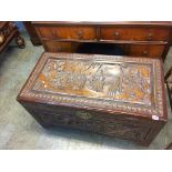 An Oriental carved camphorwood chest