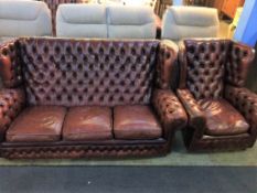 A Chesterfield high back armchair and three seater settee