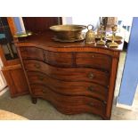 A 19th century mahogany serpentine front chest of drawers, with three short drawers, below three