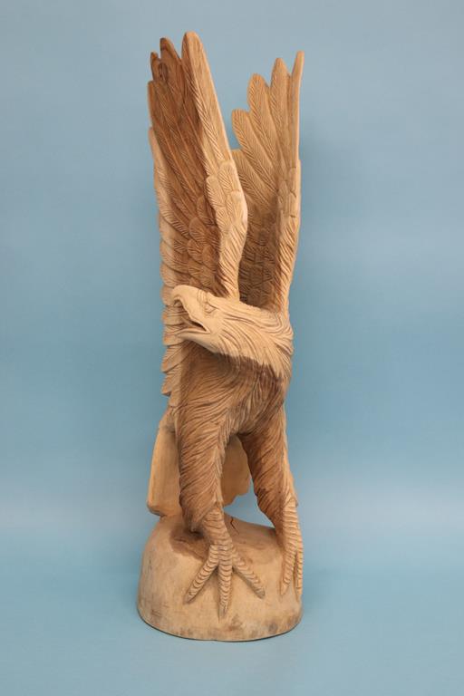 A carved wooden sculpture of an Eagle