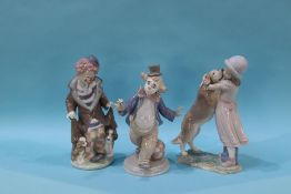 A Lladro group, 'Warm Welcome' and two clowns, boxed