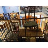 A walnut centre table and three Edwardian chairs