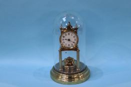 An Anniversary clock, under a glass dome