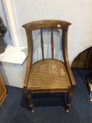 A Gillows of Lancaster rosewood bergère chair, with carved splat and spindled back, supported on