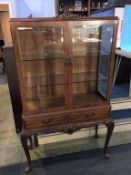 A walnut Queen Anne style display cabinet, with two drawers