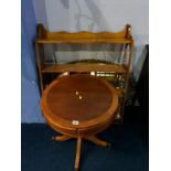 A gilt oval mirror, yew wood shelves and occasional table