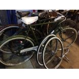 A Raleigh bike, handle bars and two spare wheels