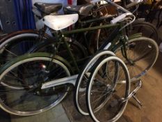 A Raleigh bike, handle bars and two spare wheels