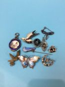 Ten enamelled and other brooches