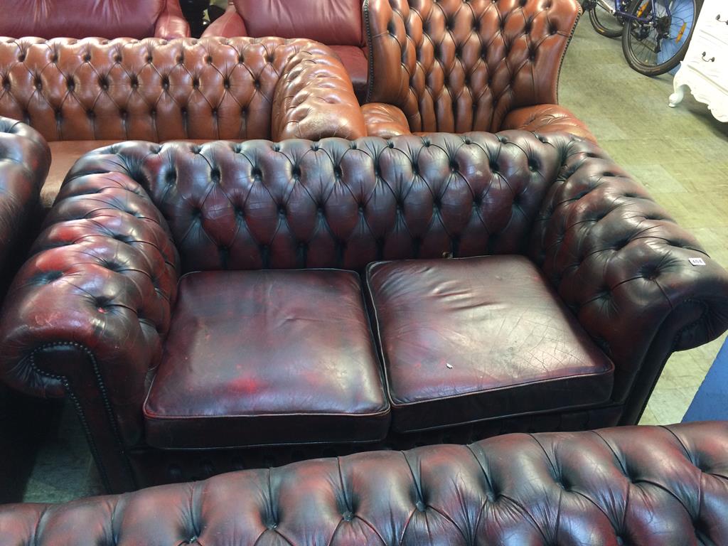 A Chesterfield oxblood two seater settee