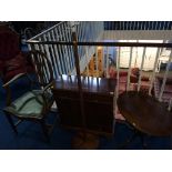 A yew wood cabinet, oval table and lamp etc.