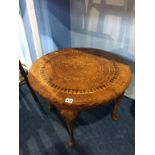 A decorative pad foot occasional table