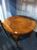 A decorative pad foot occasional table