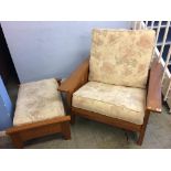 A large teak armchair and footstool