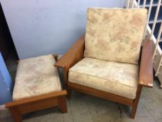 A large teak armchair and footstool