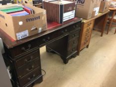 An oak desk and a reproduction pedestal desk