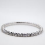 An 18ct white gold tennis bracelet, set with fifty one round brilliant cut diamonds, colour G-H,
