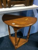 A Jaycee oak half moon side table