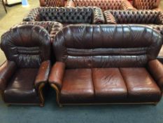 A brown leather settee and armchair