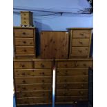 Four pine chest of drawers, pine table and a mini pine chest of drawers