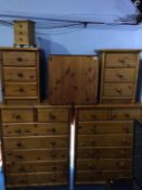 Four pine chest of drawers, pine table and a mini pine chest of drawers