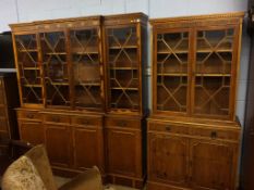 A yew wood breakfront bookcase and another bookcase