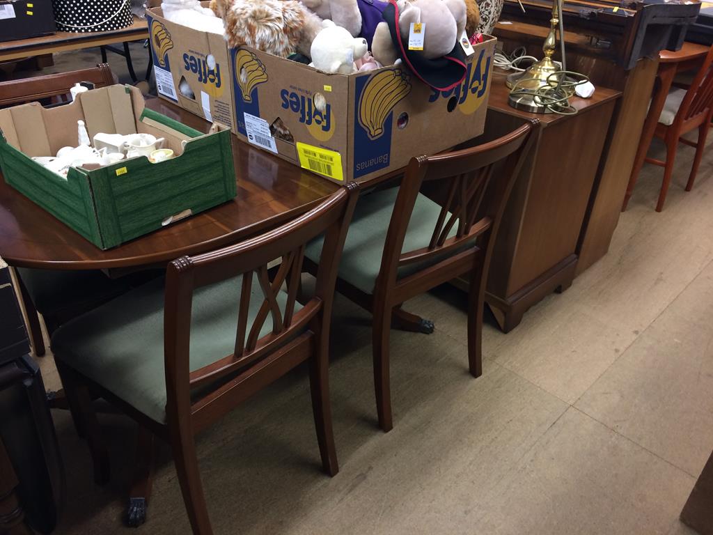 A yew wood table, four chairs, a cabinet, sliding door bookcase and various lamps