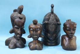 Four Tribal heads, 19.5cm wide x 40cm long, 14cm wide x 27cm long, 17cm wide x 42cm long, 14cm