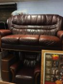 A brown leather settee and armchair