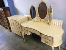 A cream dressing table and chest of drawers