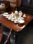 An Edwardian mahogany extending dining table, with spare leaf