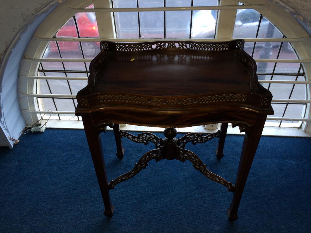 A reproduction mahogany tray top table, with pierced gallery