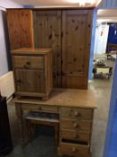 A pine wardrobe, dressing table and bedside drawers