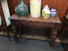 A carved oak side table