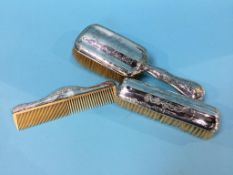 Silver backed brushes and a comb