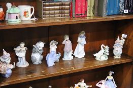 Two Lladro clowns, Lladro duck group and five Nao figures (8)