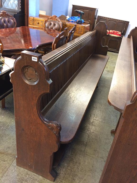 An ornate oak church pew, 265cm length