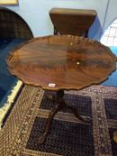 A reproduction mahogany piecrust tripod table