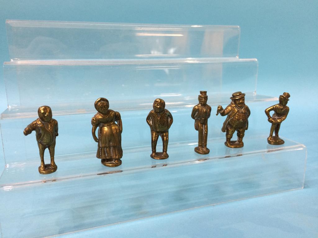 A collection of miniature brass Dickens figures