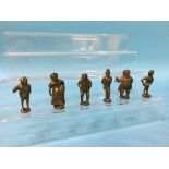 A collection of miniature brass Dickens figures