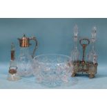 A silver mounted bottle, a plated claret jug and a plated two bottle decanter stand with bottles and