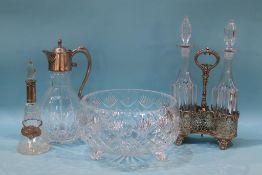 A silver mounted bottle, a plated claret jug and a plated two bottle decanter stand with bottles and