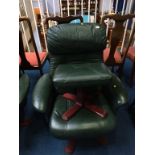 A green leather reclining armchair and footstool