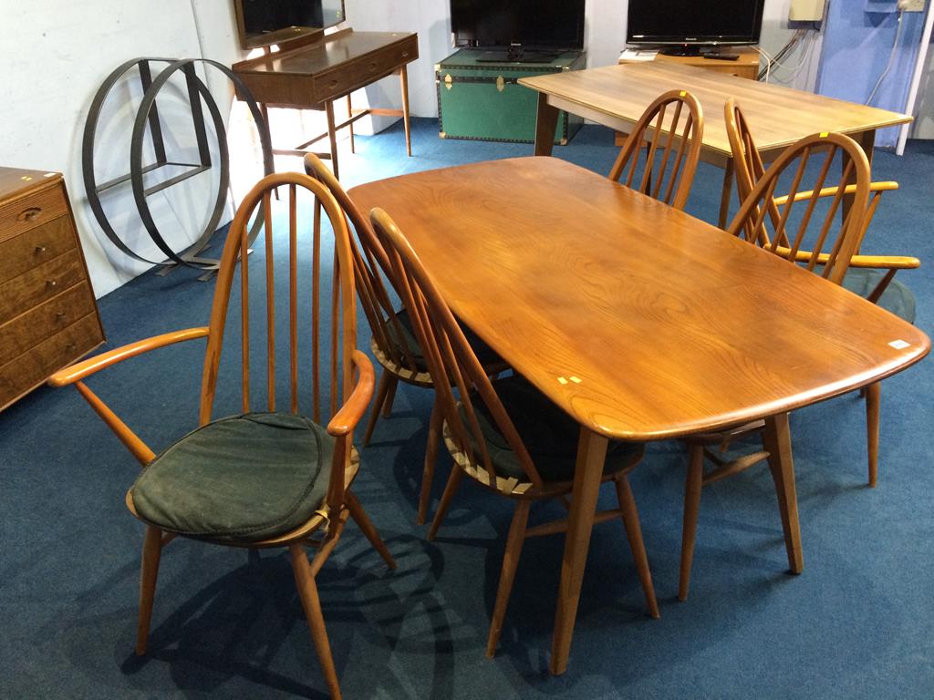 An elm Ercol table and six chairs