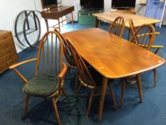 An elm Ercol table and six chairs