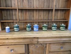 Five T. and G. Green Cloverleaf storage jars and two pieces of Cornish ware