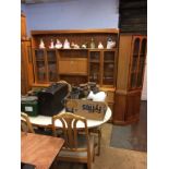 A teak wall unit, corner cabinet, table and chairs