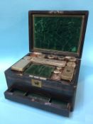 A 19th century rosewood and brass bound work box, opening to reveal a fitted interior, with silver